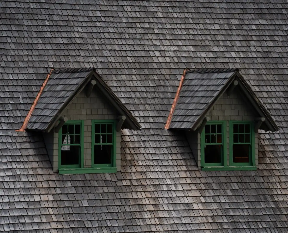 Dormers on a shingle roof in Pasadena, TX, where step flashing and kickout flashing carry water past the walls